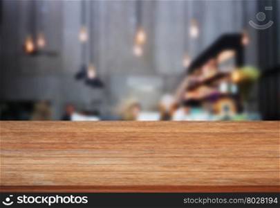 Top wooden table with blurred cafe background, stock photo