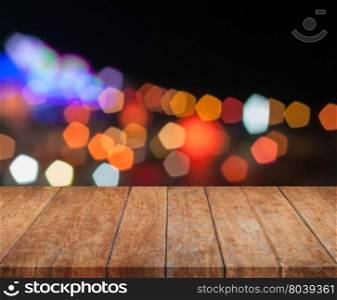 Top wooden with abstract blurred night lights, stock photo