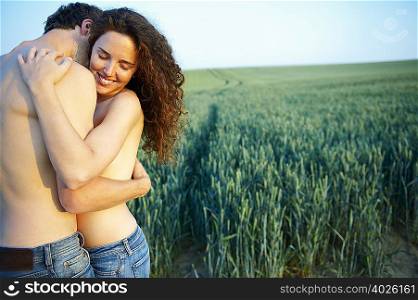 Topless couple, holding each other