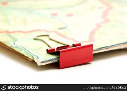 topographic map and paper clip isolated on white