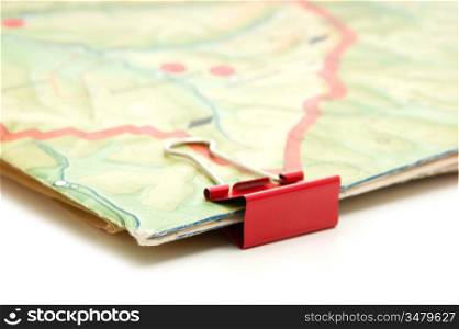topographic map and paper clip isolated on white