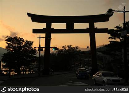 Torii gate in the evening while sunset at Chuzenji lake, Nikko, Japan