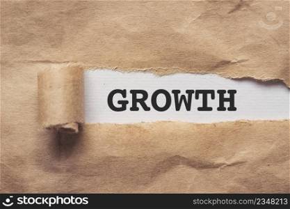Torn brown paper on white background the text growth