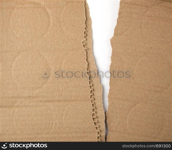 torn in half brown sheet of paper from under the box, a slot in the middle, full frame