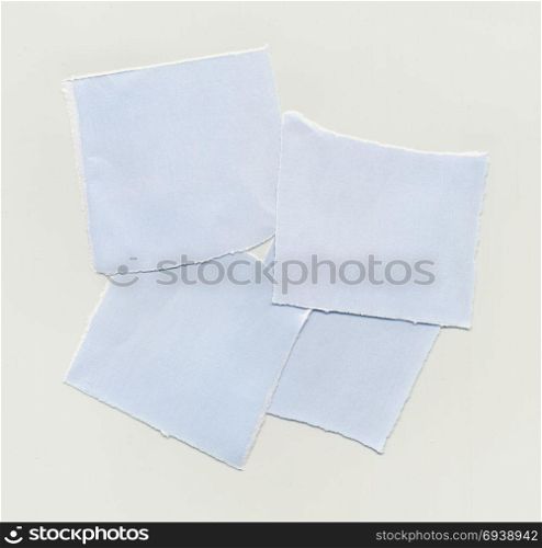 Torn paper pieces. Torn paper note over light brown paper background