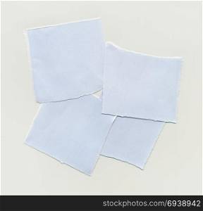 Torn paper pieces. Torn paper note over light brown paper background
