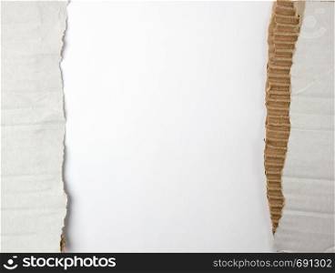 torn piece of paper from under the box in half on a white background, close up