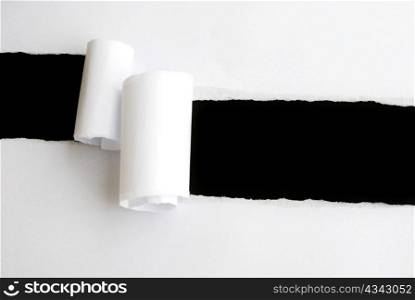 torn white sheet of paper with black background and copyspace