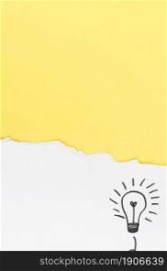 torn yellow paper with hand drawn light bulb white background. High resolution photo. torn yellow paper with hand drawn light bulb white background. High quality photo