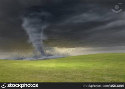 Tornado in meadow. Image of powerful huge tornado twisting in meadow