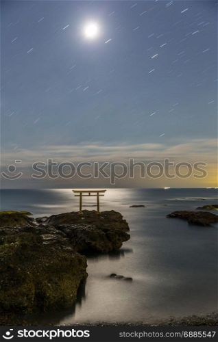 Toroii Japanese shrine gate sunrise at sea Oarai city , Ibaraki Japan