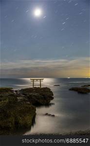 Toroii Japanese shrine gate sunrise at sea Oarai city , Ibaraki Japan