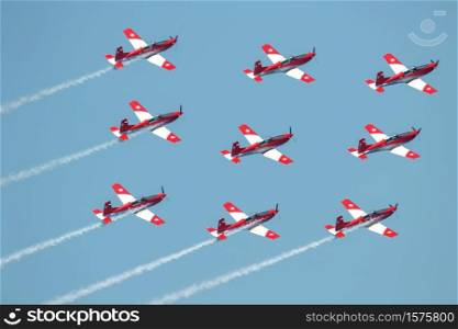 TORRE DEL MAR, MALAGA, SPAIN-JUL 28: Aircraft of the Swiss air force PC-7 Team taking part in a exhibition on the 3rd airshow of Torre del Mar on July 28, 2018, in Torre del Mar, Malaga, Spain. Swiss air force PC-7 Team