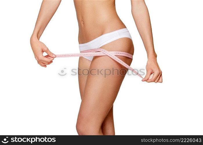 Torso of luxurious woman in white bikini studio shot. Torso of woman in white bikini sunbathing