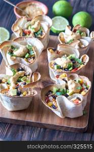 Tortilla burrito bowls stuffed with rice and vegetables