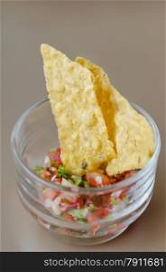 Tortilla Chips With Salsa Dip. Tortilla chips with salsa dip in cocktail glass