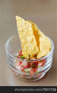 Tortilla Chips With Salsa Dip. Tortilla chips with salsa dip in cocktail glass