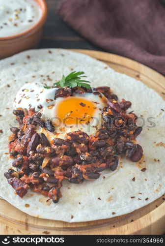 Tortilla with chipotle bean chili and baked egg