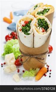 tortilla wraps with chicken and fresh vegetables isolated on white