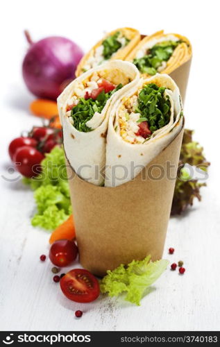 tortilla wraps with chicken and fresh vegetables isolated on white