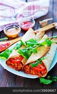 tortilla wraps with meat and vegetables on plate