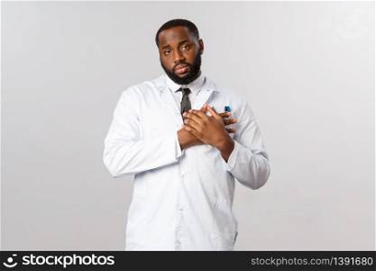 Touched handsome physician, therapist or doctor touching heart, feel grateful or pleased, look flattered camera, receive heartwarming gesture from caring patient or coworker, grey background.. Touched handsome physician, therapist or doctor touching heart, feel grateful or pleased, look flattered camera, receive heartwarming gesture from caring patient or coworker, grey background