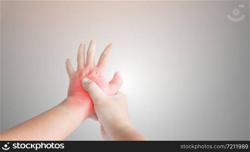 Touching her injured hand, Disease concept.Carpal Tunnel Syndrome.