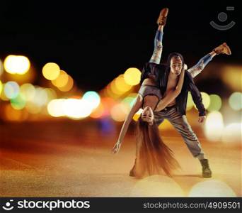 Tough hip hop man dancing with his girlfriend