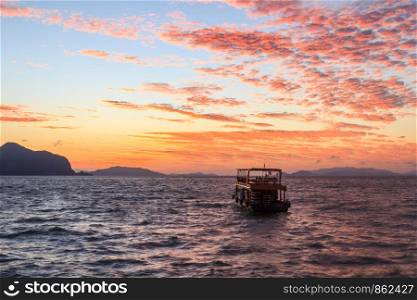 Tour boat in Phang Nga Bay at dawn, Thailand