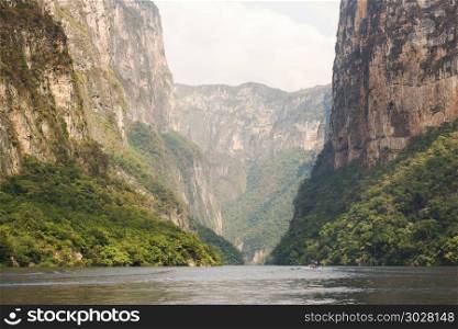 Tour Boats In Sumidero Canyon Chiapas. Tour boats and tourists travel through the Sumidero Canyon Chiapas, Mexico