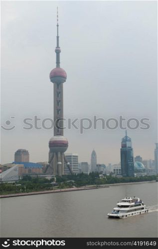 Tourboat with the Oriental Pearl Tower in the background, Pudong, Shanghai, China
