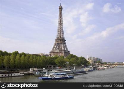 Tourboats moored in a river near a tower, Eiffel Tower, Seine River, Paris, France