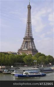 Tourboats moored in a river with a tower in background, River Seine, Eiffel Tower, Paris, France