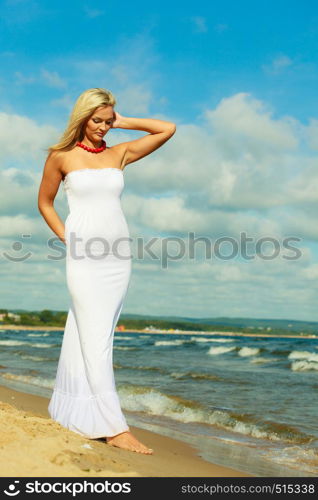 Tourism and recreation. Beauty attractive woman walking on sea edge. Female tourist resting on fresh air on seaside.. Female tourist walking on beach.