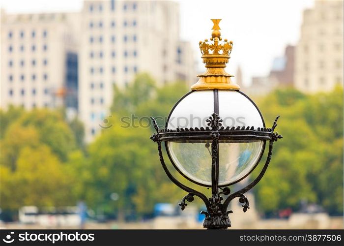 Tourism and travel. Closeup victorian street lamp in London blurred city background