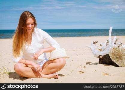 Tourism and traveling. Happy attractive woman tourist resting on sunny beach. Young girl enjoy her free time on seaside. Summer time.. Female tourist resting on beach.