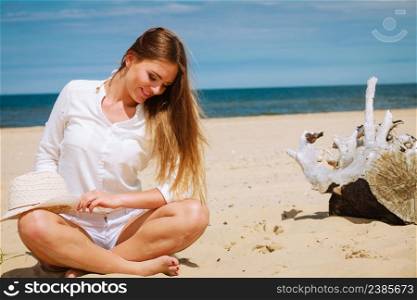 Tourism and traveling. Happy attractive woman tourist resting on sunny beach. Young girl enjoy her free time on seaside. Summer time.. Female tourist resting on beach.