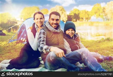tourism, hike and travel concept - happy family over tent at camp site. happy family with tent at camp site