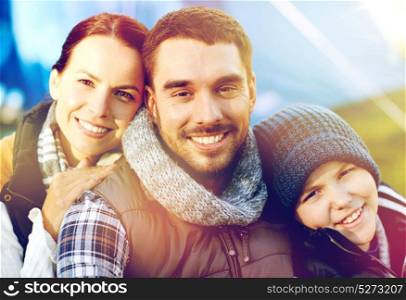 tourism, hike and travel concept - happy family portrait over tent at camp site. happy family portrait over tent at camp site