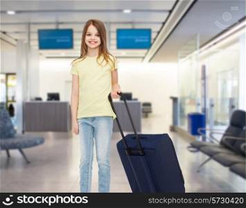 tourism, holiday, vacation, childhood and transportation concept - smiling little girl with travel bag over airport background