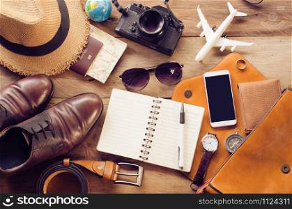 Tourism planning and equipment needed for the trip on wooden floor