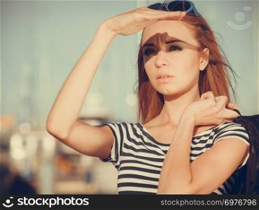 Tourism relax and people concept. Fashion blonde girl in marina against yachts in port