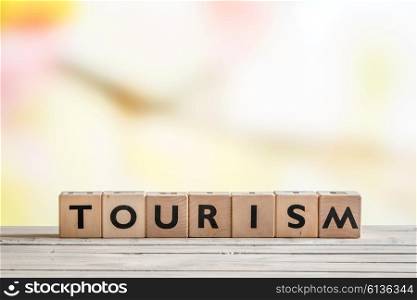 Tourism sign created with cubes on a wooden desk