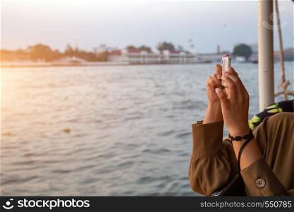 tourism take photo with mobile phone to capture moment in destination of Bangkok ,Thailand