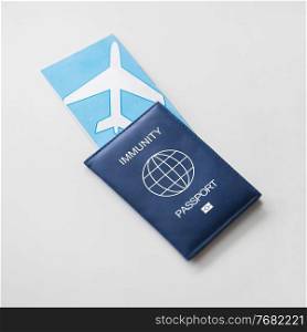 tourism, travel and health care concept - immunity passport and air tickets for on white background. immunity passport and air tickets for travel