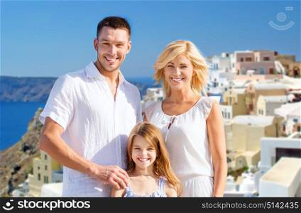 tourism, travel and people concept - happy family over santorini island background. happy family over santorini island background