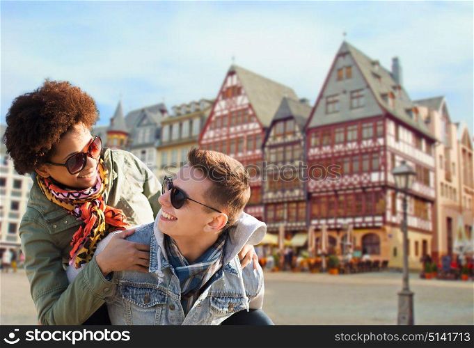 tourism, travel and people concept - happy teenage couple in shades having fun over frankfurt am main city street background. happy couple having fun in frankfurt