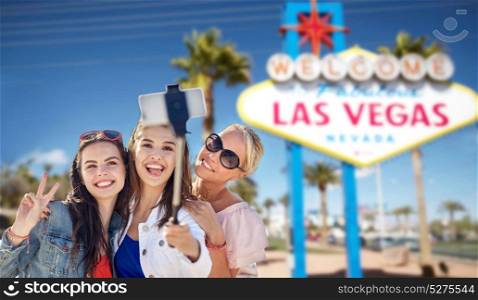 tourism, travel and summer vacation concept - group of happy smiling women or friends over welcome to fabulous las vegas sign background. group of happy women or friends at las vegas