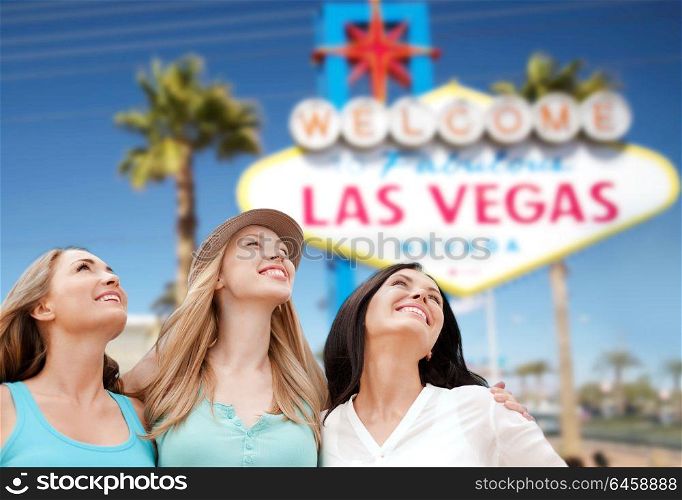 tourism, travel and summer vacation concept - group of happy smiling women or friends over welcome to fabulous las vegas sign background. group of happy women or friends at las vegas