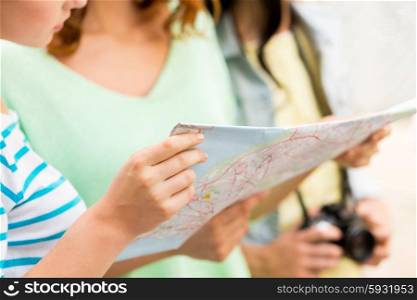 tourism, travel, leisure, holidays and friendship concept - close up of women with map and camera outdoors